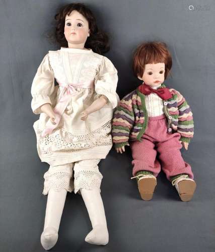 Two dolls, one with blue glass eyes, closed mouth and brown ...