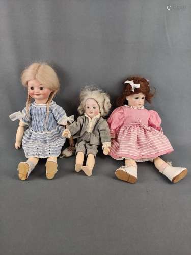 Three porcelain dolls, one doll by Simon and Halbig, with bl...
