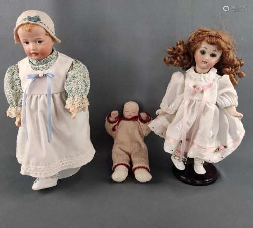 Three dolls, one in flowered dress and white shoes, bisque p...
