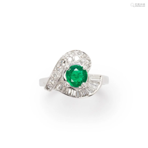 An emerald, diamond and fourteen karat white gold ring