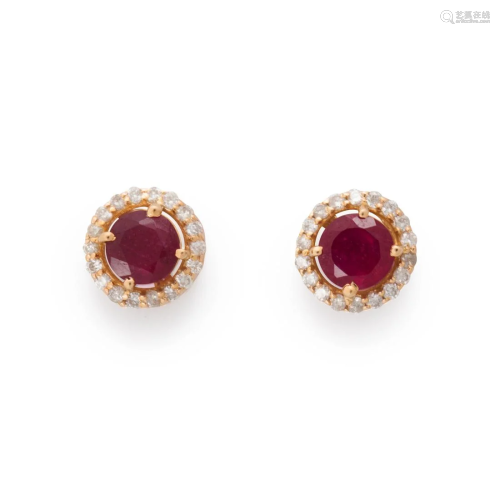 A pair of ruby, diamond and fourteen karat gold stud earring...