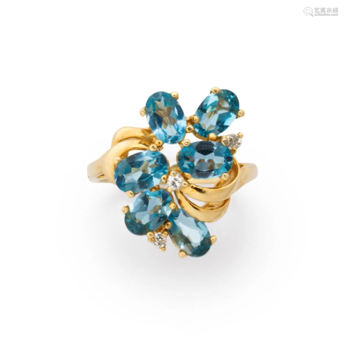 A blue topaz, diamond and fourteen karat gold ring