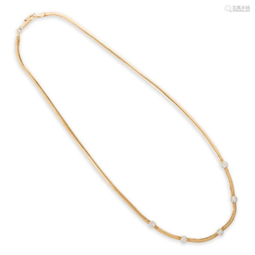 A diamond and fourteen karat bi-color gold necklace