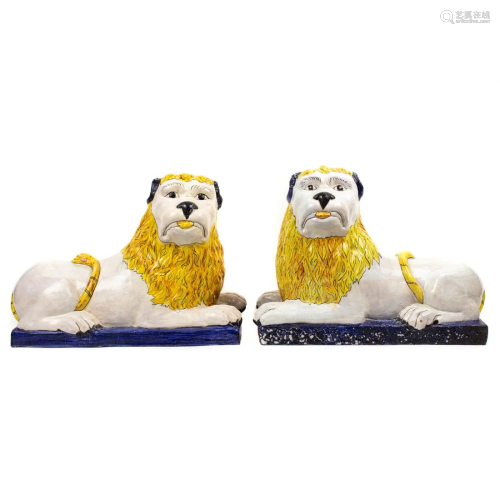 A pair of Continental pottery figures of recumbent lions
