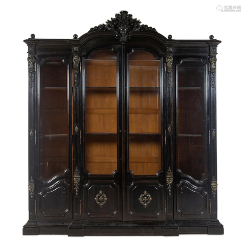 An Italian Rococo Revival Carved Ebonized Bookcase