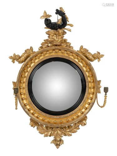A Regency Parcel Ebonized Giltwood Convex Girandole Mirror