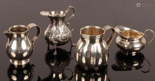 Four silver jugs, including one of baluster shape, London 19...
