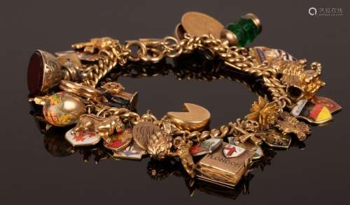 An 18ct gold curb link charm bracelet, hung with a Victorian...