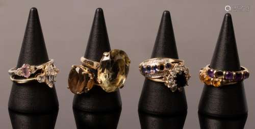 An imitation diamond three-stone ring set in 14k yellow gold...