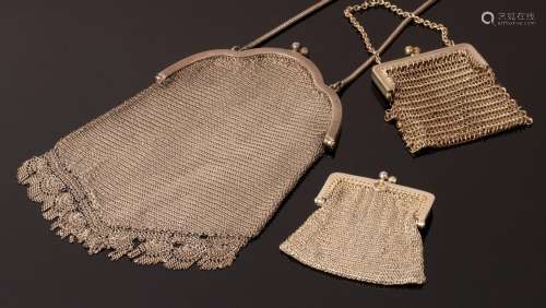 A ladys white metal chain mail evening bag and two similar c...
