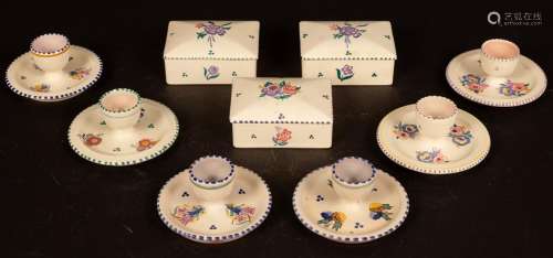 Poole Pottery, six floral decorated egg cups and three flora...