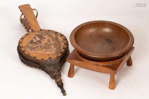 A pair of leather covered bellows decorated a street scene t...