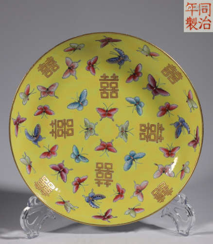Yellow enamel plate with butterfly pattern of happy characte...