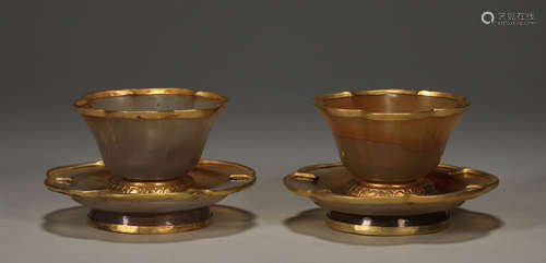 A pair of golden lotus cups encased in agate from the Qing D...