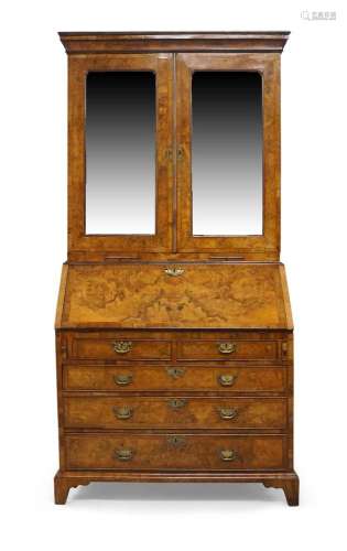 A George II figured walnut bureau bookcase, the moulded corn...
