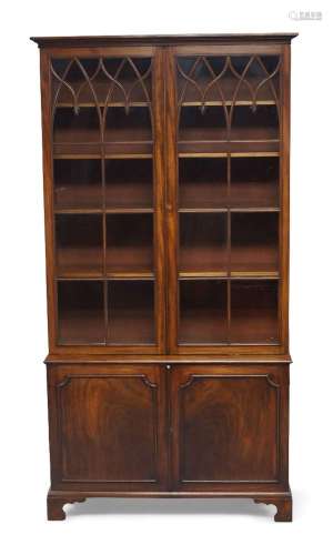 A George III mahogany bookcase, the moulded cornice above pa...