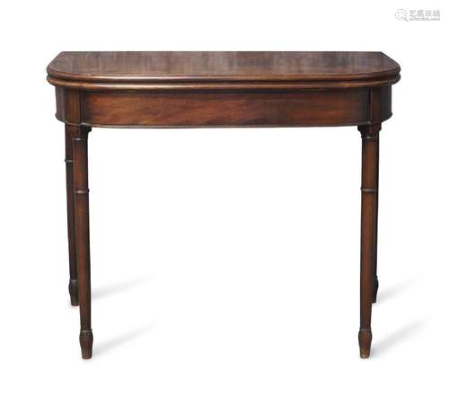 A Regency mahogany fold over card table, raised on ring turn...