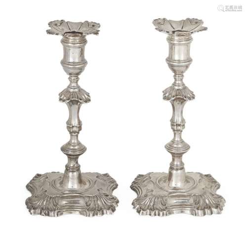 A pair of George II cast silver candlesticks