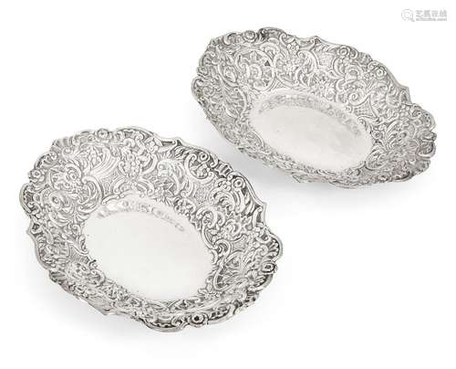 A pair of late Victorian repousse silver dishes