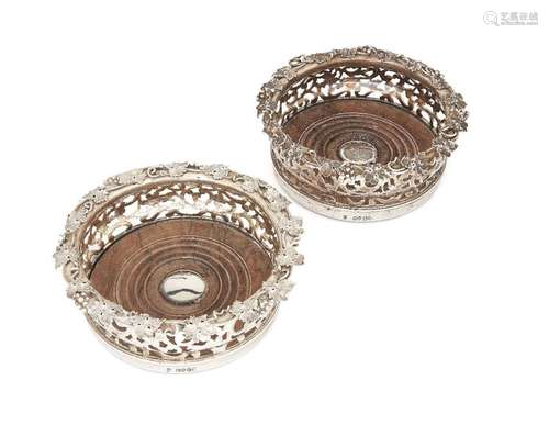 A pair of early Victorian silver wine coasters