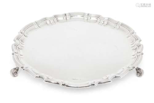 A silver salver with pie crust border