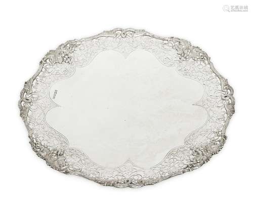 A footed silver dish with foliate pierced sides