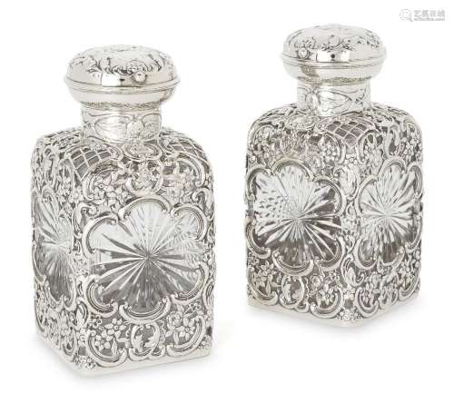 A pair of Edwardian silver mounted glass vanity jars with pu...