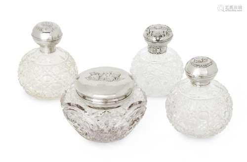 Four putti-decorated silver mounted glass vanity vessels com...