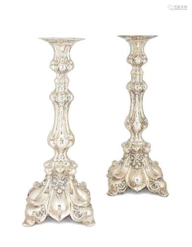 A pair of continental white metal candlesticks