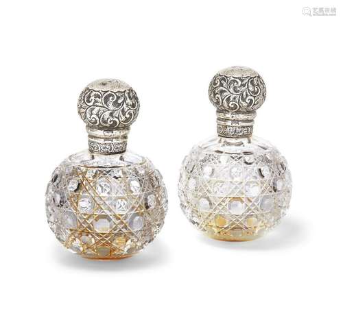 A pair of silver mounted glass perfume bottles