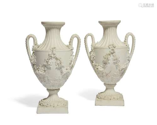 A pair of Derby white biscuit porcelain two-handled vases