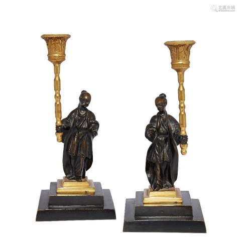 A pair of Regency gilt and patinated bronze candlesticks
