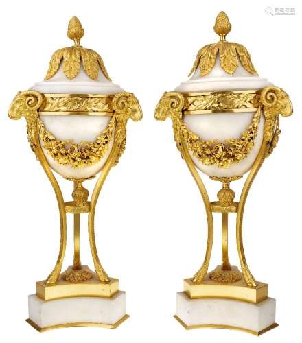 A pair of French gilt-bronze-mounted marble urns and covers