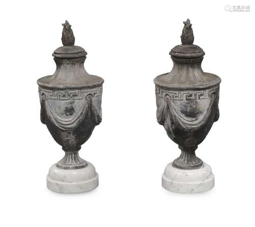 A pair of lead urns and covers
