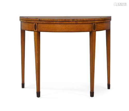 A George III satinwood fold over tea table