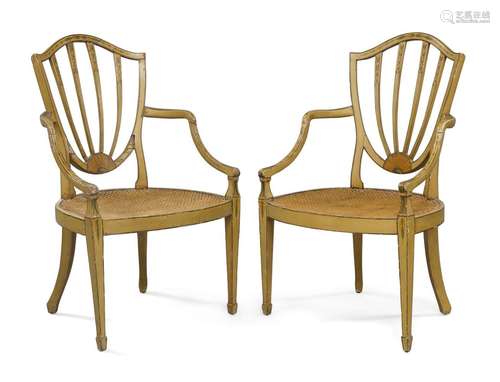 A pair of George III painted caned elbow chairs