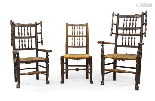 A near pair of oak wing back armchairs