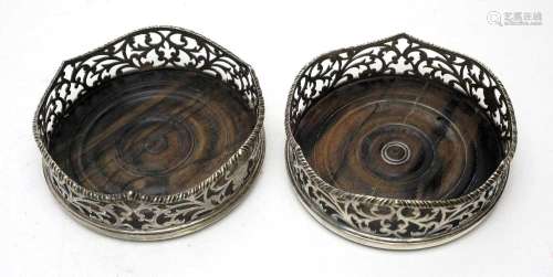 A pair of early Victorian silver mounted coasters,