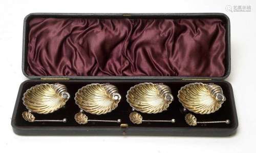 A set of four silver table salts with matching spoons
