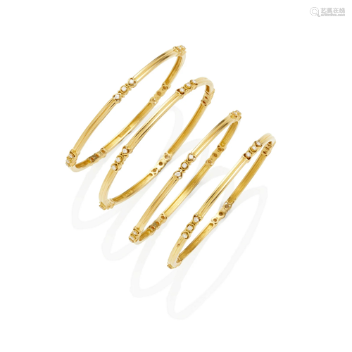 A SET OF FOUR 18K GOLD AND DIAMOND BRACELETS