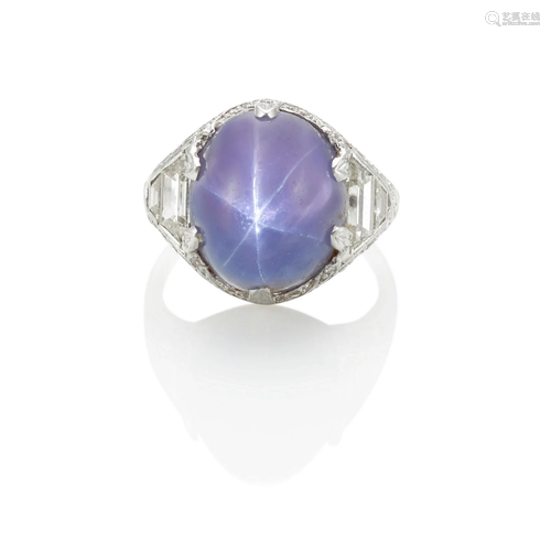 A PLATINUM, VIOLET STAR SAPPHIRE AND DIAMOND RING