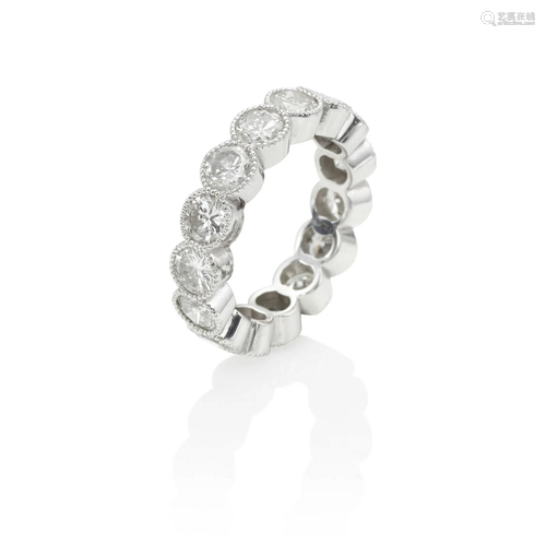 AN 18K WHITE GOLD AND DIAMOND ETERNITY RING