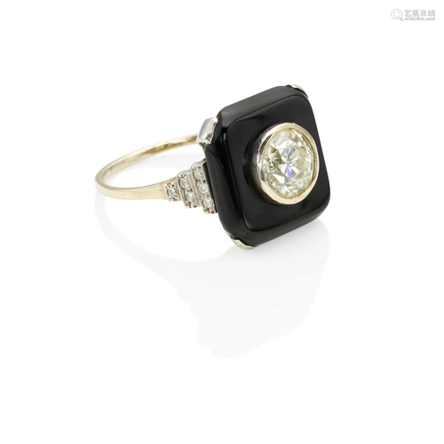 A PLATINUM, 18K GOLD, ONYX AND DIAMOND RING