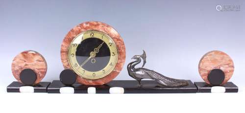 An Art Deco rouge marble, slate and onyx mantel clock garnit...