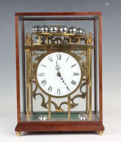 A late 20th century brass spherical weight clock timepiece, ...