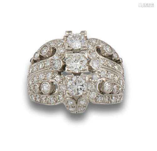 Platinum bombé ring formed by bands of openwork diamonds, br...