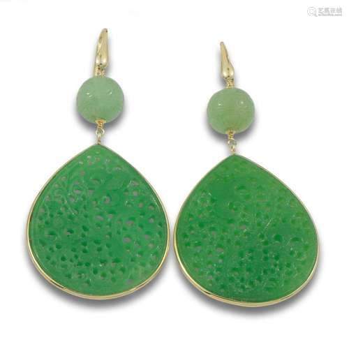 Long carved jade earrings, with golden silver details.