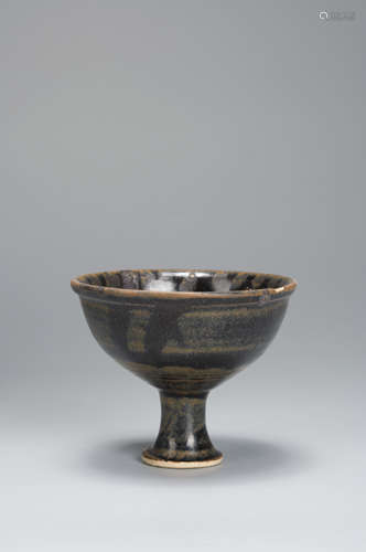 A black glazed porcelain cup