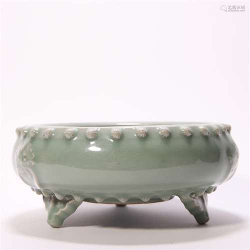 A celadon glazed porcelain three-legged basin