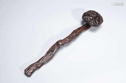 A carved red sandalwood ruyi